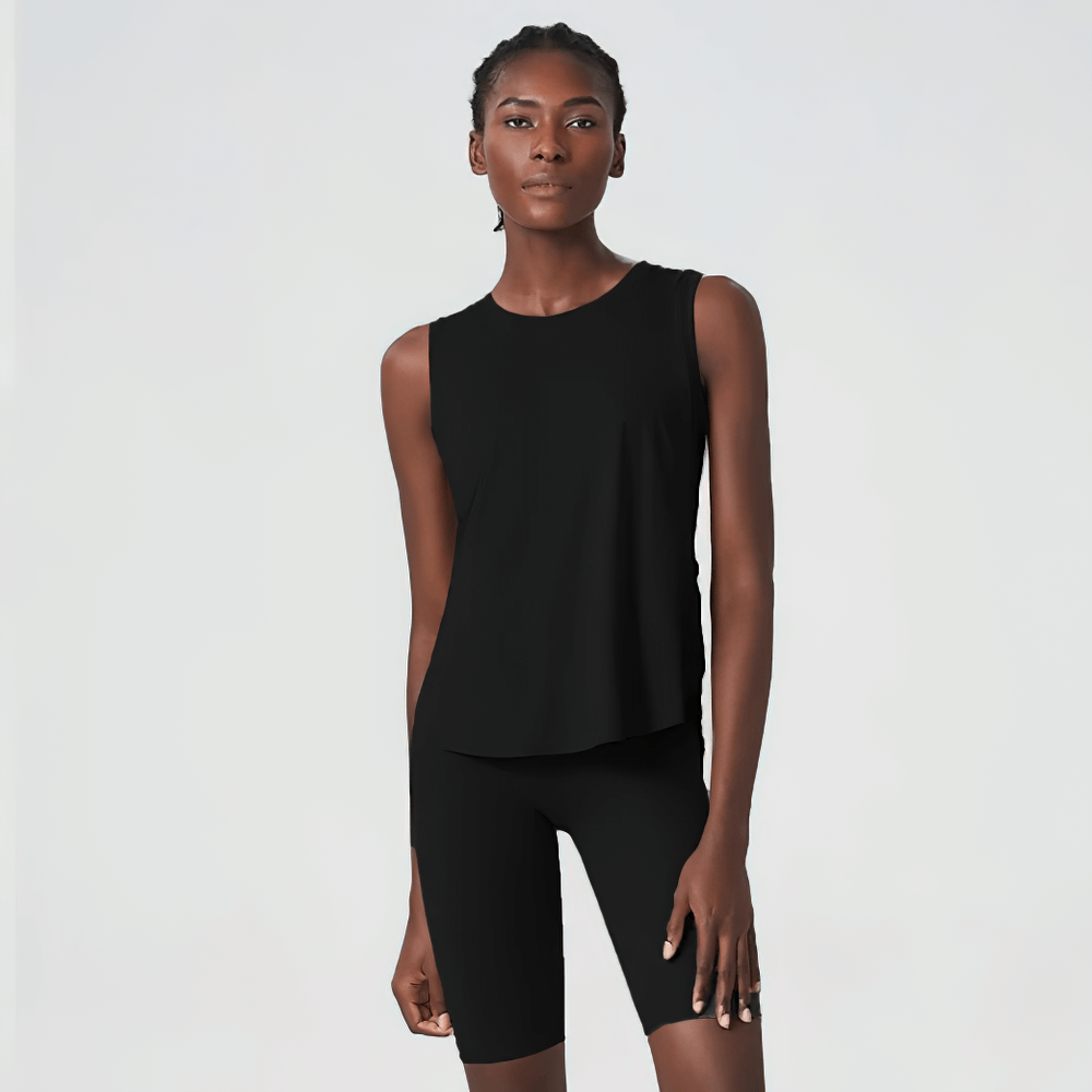 Woman wearing solid black running tank top and shorts, perfect for yoga and running. Shop the latest activewear collection SF2094.